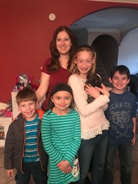 a woman and her children are posing for a picture